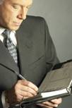 man in business suit writing